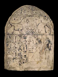 Stela showing a man and woman adoring two cats who are manifestations of the two aspects of the sun-god, Re and Atum, found at Deir el-Medina